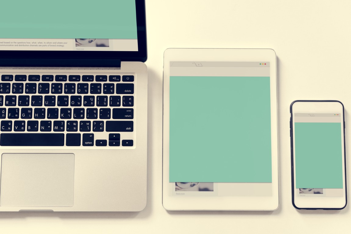 Responsive website design displayed across multiple devices on a desk