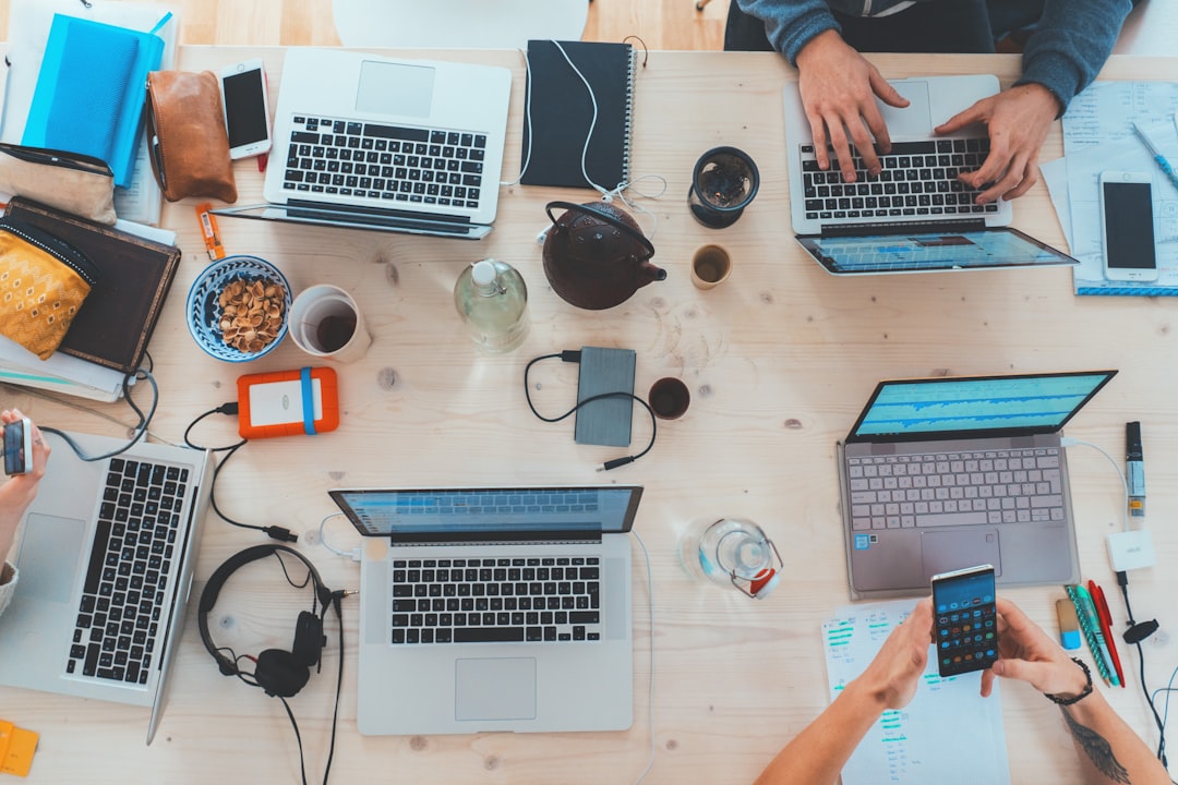 schema for ai search — people sitting down near table with assorted laptop computers